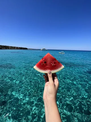 Seasonal watermelon served beside the turquoise Blue Lagoon